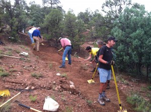 Volunteers rapidly turn an eroding gully into a smoothly sloped tread that sheds water.